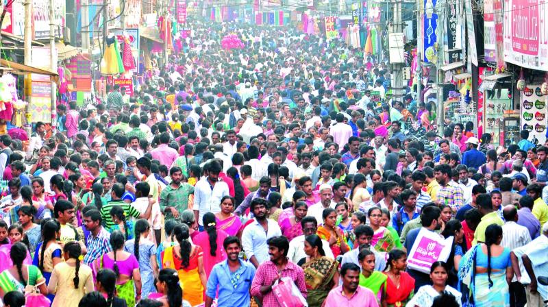 People throng main road to purchase clothes and other items on the eve of Sankranti in Rajahmundry on Saturday, Even people from Samalkota, Ravulapalem, Nidavolu and Kovvuru came for shopping. (Photo: DC) People throng main road to purchase clothes and other items on the eve of Sankranti in Rajahmundry on Saturday, Even people from Samalkota, Ravulapalem, Nidavolu and Kovvuru came for shopping. (Photo: DC)