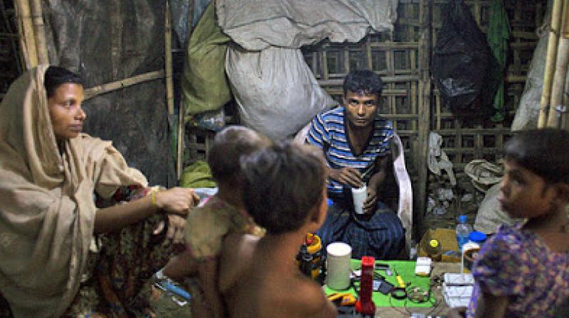 A Rohingya man, woman and children gather in a shop in the Thel-Chaung displacement camp in Sittwe, eastern Myanmar's Rakhine state. (Photo: AFP) A Rohingya man, woman and children gather in a shop in the Thel-Chaung displacement camp in Sittwe, eastern Myanmar's Rakhine state. (Photo: AFP)