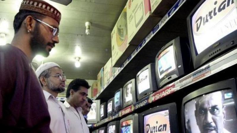 People watch TV programes in Karachi. (Photo: AFP) People watch TV programes in Karachi. (Photo: AFP)