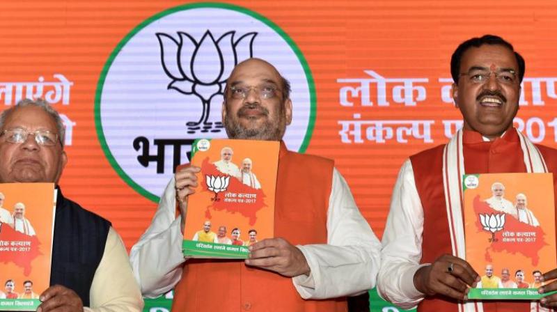 BJP President Amit Shah with UP BJP chief Keshav Prasad Maurya releasing party manifesto for the upcoming Uttar Pradesh assembly elections in Lucknow. (Photo: PTI) BJP President Amit Shah with UP BJP chief Keshav Prasad Maurya releasing party manifesto for the upcoming Uttar Pradesh assembly elections in Lucknow. (Photo: PTI)