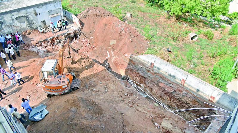 Workers remove debris from the site where the wall collapsed at Premnagar in Amberpet on Saturday. (Image: S. Surender Reddy) Workers remove debris from the site where the wall collapsed at Premnagar in Amberpet on Saturday. (Image: S. Surender Reddy)