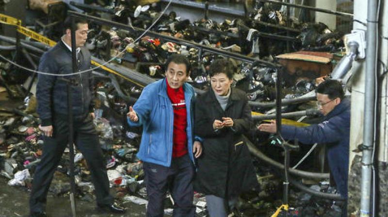 Park Geun-hye's office says she visited the market to review a recent fire, which destroyed hundreds of shops there. (Photo: AP) Park Geun-hye's office says she visited the market to review a recent fire, which destroyed hundreds of shops there. (Photo: AP)