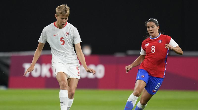 Canadas Quinn (left) and Chiles Karen Araya vie for the ball during a womens soccer match at the Tokyo Olympic. (Photo AP)