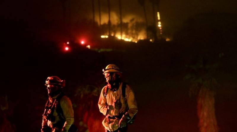 Firefighters battle several intense wind-driven wildfires early on Friday that have swept across densely populated Southern California, destroying at least 500 structures. (Photo: AP) Firefighters battle several intense wind-driven wildfires early on Friday that have swept across densely populated Southern California, destroying at least 500 structures. (Photo: AP)