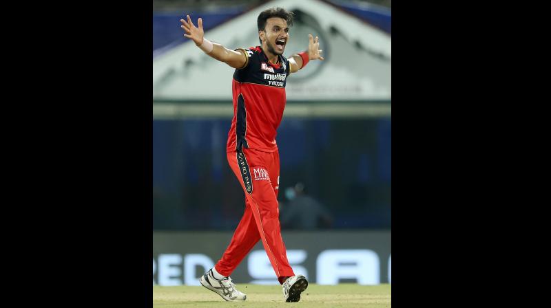 RCB pacer Harshal Patel celebrates a Mumbai Indians wicket in the IPL-14 opener in Chennai on Friday. — IPL RCB pacer Harshal Patel celebrates a Mumbai Indians wicket in the IPL-14 opener in Chennai on Friday. — IPL