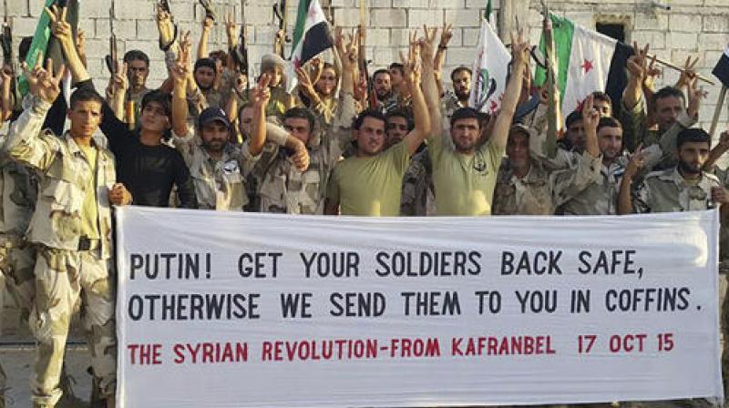 Free Syrian Army fighters of Fursan al-Haq Brigade hold a banner, in Kafranbel, Idlib province, northern Syria. The battle for Aleppo has gripped the world, but it is hardly the only active front across Syria. One of the next targets for the forces of Bashar Assad will probably be the heartland of rebel territory, the neighboring Idlib province. (Photo: AP) Free Syrian Army fighters of Fursan al-Haq Brigade hold a banner, in Kafranbel, Idlib province, northern Syria. The battle for Aleppo has gripped the world, but it is hardly the only active front across Syria. One of the next targets for the forces of Bashar Assad will probably be the heartland of rebel territory, the neighboring Idlib province. (Photo: AP)