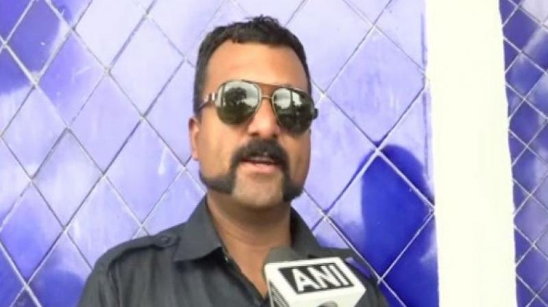 Speaking to ANI, the policeman said instead of following the latest trends and copying 'fake heroes' like film stars, he chose to copy Abhinandan's style. (Photo: ANI) Speaking to ANI, the policeman said instead of following the latest trends and copying 'fake heroes' like film stars, he chose to copy Abhinandan's style. (Photo: ANI)