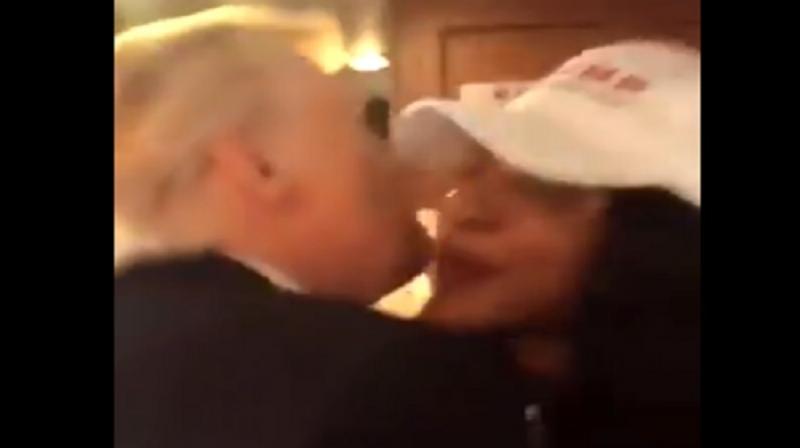 In the brief video, which was reportedly taken by campaign volunteer Brian Hayes, Trump was seen placing both of his arms on Johnson's shoulders and appears to plant a kiss near her right cheek, though it's not completely clear if he makes contact with her mouth. (Photo: Screengrab) In the brief video, which was reportedly taken by campaign volunteer Brian Hayes, Trump was seen placing both of his arms on Johnson's shoulders and appears to plant a kiss near her right cheek, though it's not completely clear if he makes contact with her mouth. (Photo: Screengrab)