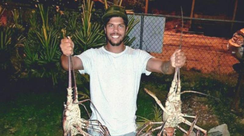 Umesh Yadav posted a rather bizarre picture on Instagram, of himself holding two massive lobsters upside down. (Photo: Umesh Yadav/ Instagram) Umesh Yadav posted a rather bizarre picture on Instagram, of himself holding two massive lobsters upside down. (Photo: Umesh Yadav/ Instagram)