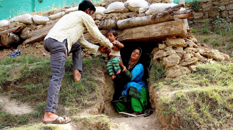 Border migrants take shelter in a bunker after shelling from Pakistan side at Nowshera sector of Rajouri district on Saturday. (Photo: PTI) Border migrants take shelter in a bunker after shelling from Pakistan side at Nowshera sector of Rajouri district on Saturday. (Photo: PTI)