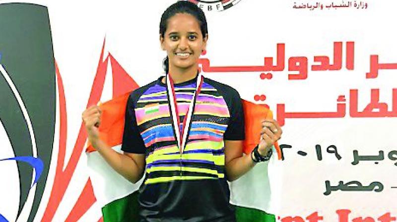 Sri Krishna Priya poses with the Indian flag and her medal after the presentation ceremony of the Egypt International Badminton tournament in Cairo on Sunday. Sri Krishna Priya poses with the Indian flag and her medal after the presentation ceremony of the Egypt International Badminton tournament in Cairo on Sunday.