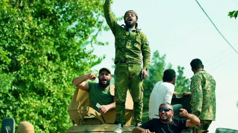 Turkish-backed Syrian opposition fighters chant slogans as they wait to cross the border into Syria, in Akcakale, Sanliurfa province, southeastern Turkey. (Photo: AP) Turkish-backed Syrian opposition fighters chant slogans as they wait to cross the border into Syria, in Akcakale, Sanliurfa province, southeastern Turkey. (Photo: AP)