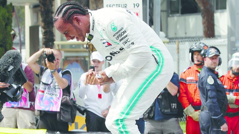 Mercedes driver Lewis Hamilton celebrates after taking the pole in Monaco on Saturday. (Photo: AP) Mercedes driver Lewis Hamilton celebrates after taking the pole in Monaco on Saturday. (Photo: AP)
