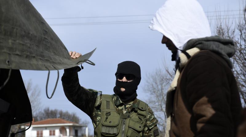 Greek Army detain migrants in the village of Mandra, Evros region, at the Greek-Turkish border on Tuesday. AP Photo