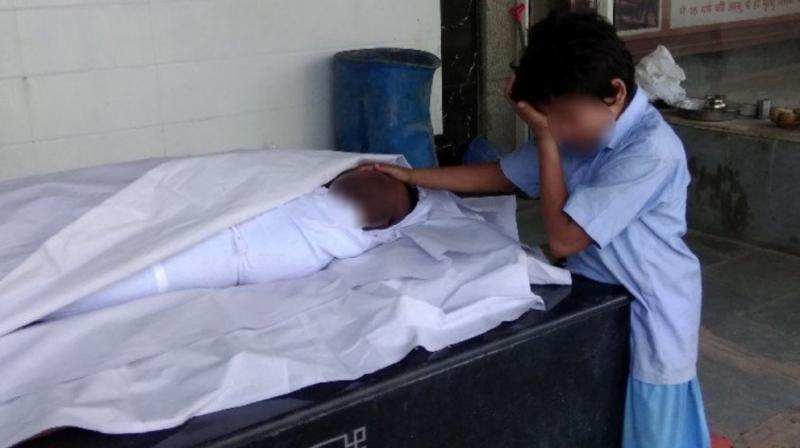 In the photograph shared widely by social media users, the boy, believed to be Anil's son, was seen grieving next to his body. (Photo: Twitter | Screengrab) In the photograph shared widely by social media users, the boy, believed to be Anil's son, was seen grieving next to his body. (Photo: Twitter | Screengrab)