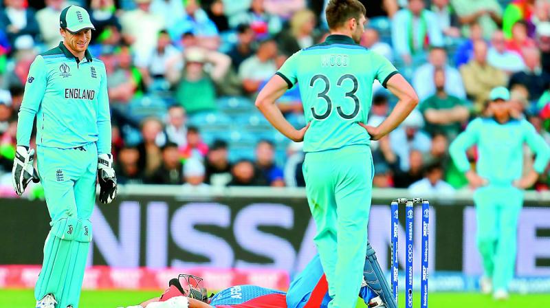 Afghanistan’s Hashmatullah Shahidi lies on the ground after he was hit by fast bowler Mark Wood’s delivery during the match against England at Old Trafford in Manchester on Tuesday. (Photo: AP) Afghanistan’s Hashmatullah Shahidi lies on the ground after he was hit by fast bowler Mark Wood’s delivery during the match against England at Old Trafford in Manchester on Tuesday. (Photo: AP)