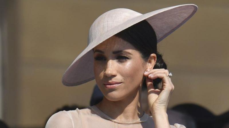 Meghan, the Duchess of Sussex gestures as she attends a garden party at Buckingham Palace in London, Tuesday May 22, 2018, her first royal engagement since her wedding to Prince Harry on Saturday. (Photo: AP) Meghan, the Duchess of Sussex gestures as she attends a garden party at Buckingham Palace in London, Tuesday May 22, 2018, her first royal engagement since her wedding to Prince Harry on Saturday. (Photo: AP)