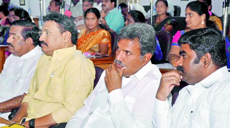 MP Kesineni Srinivas, MLA Gadde Rammohan and Mayor Koneru Sridhar listen to municipal commissioner G. Veerapandian on the details of the storm water drainage system to at the council hall in Vijayawada on Friday. (Photo: DC) MP Kesineni Srinivas, MLA Gadde Rammohan and Mayor Koneru Sridhar listen to municipal commissioner G. Veerapandian on the details of the storm water drainage system to at the council hall in Vijayawada on Friday. (Photo: DC)