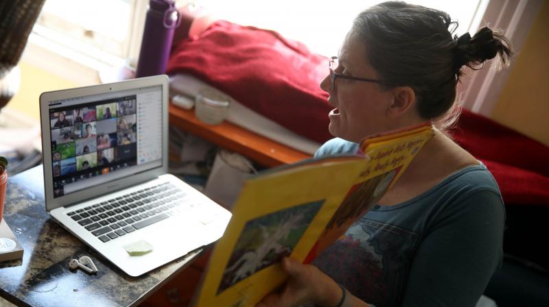Leanne Francis, first grade teacher at Harvey Milk Civil Rights Academy, conducts an online class from her living room on March 20, 2020 in San Francisco, California. (Photo | AFP) Leanne Francis, first grade teacher at Harvey Milk Civil Rights Academy, conducts an online class from her living room on March 20, 2020 in San Francisco, California. (Photo | AFP)