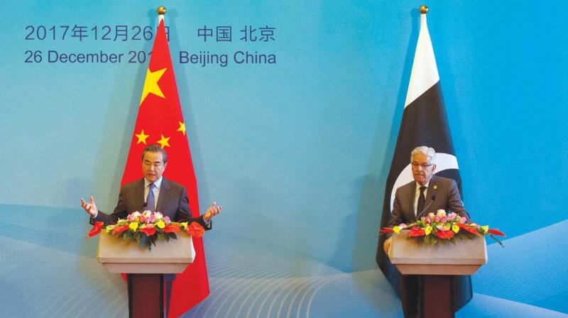Chinese foreign minister Wang Yi flanked by his Pak counterpart Khawaja Asif at the 1st China-Afghanistan-Pakistan Foreign Ministers' meet. Chinese foreign minister Wang Yi flanked by his Pak counterpart Khawaja Asif at the 1st China-Afghanistan-Pakistan Foreign Ministers' meet.