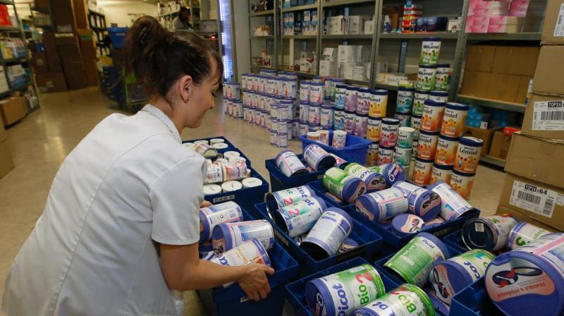 A drugstore employee removes baby milk boxes from the stock in Anglet, southwestern France. Photo:AP A drugstore employee removes baby milk boxes from the stock in Anglet, southwestern France. Photo:AP