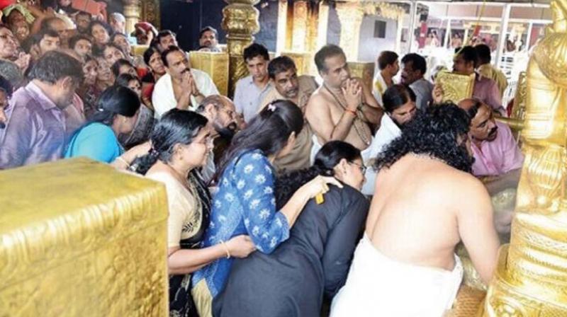 The photograph circulating in social media of women in the prohibited age group in the sanctum sanctorum of the Sabarimala Ayyappa temple recently. (File photo) The photograph circulating in social media of women in the prohibited age group in the sanctum sanctorum of the Sabarimala Ayyappa temple recently. (File photo)