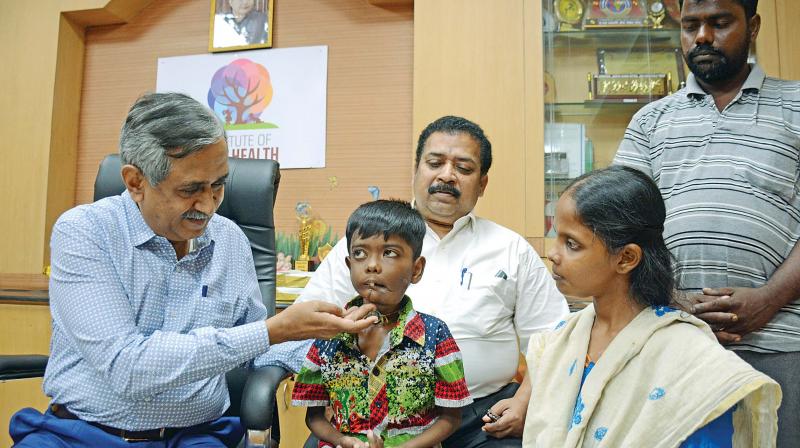 Dr K. Jayachandran, director, ICH, interacting with Ebenezer after successful removal of his lower jaw tumour by doctors at ICH. (Photo: DC) Dr K. Jayachandran, director, ICH, interacting with Ebenezer after successful removal of his lower jaw tumour by doctors at ICH. (Photo: DC)