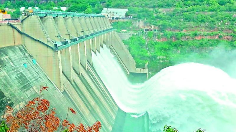 The water level in Srisailam reservoir touched a peak of 881 feet against the full reservoir level of 885 feet before the seven shutters of the dam were opened on Saturday. (Image: DC) The water level in Srisailam reservoir touched a peak of 881 feet against the full reservoir level of 885 feet before the seven shutters of the dam were opened on Saturday. (Image: DC)