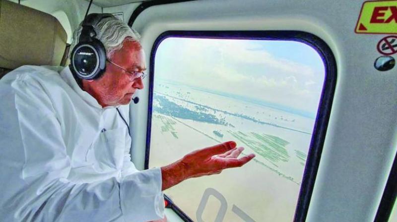 Bihar chief minister Nitish Kumar takes a survey of the flood-hit areas, in Patna, Friday. (Photo: PTI) Bihar chief minister Nitish Kumar takes a survey of the flood-hit areas, in Patna, Friday. (Photo: PTI)