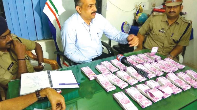 District police chief Debesh Kumar Behera shows the money seized from Manjeri. (Photo: DC) District police chief Debesh Kumar Behera shows the money seized from Manjeri. (Photo: DC)