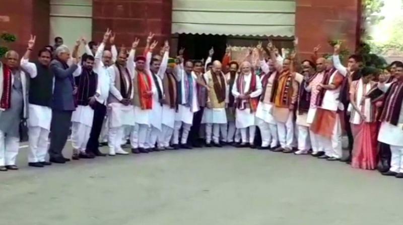 A large contingent of the party members posed with smiles and holding up the victory sign for photos near the Prime Minister’s Office. (Photo: Twitter | ANI) A large contingent of the party members posed with smiles and holding up the victory sign for photos near the Prime Minister’s Office. (Photo: Twitter | ANI)