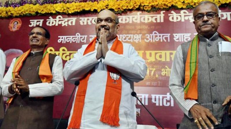 BJP national president Amit Shah with Madhya Pradesh Chief Minister Shivraj Singh Chouhan and state president Nand Kumar Singh Chouhan during his three-day visit to the state, in Bhopal on Friday. (Photo; PTI) BJP national president Amit Shah with Madhya Pradesh Chief Minister Shivraj Singh Chouhan and state president Nand Kumar Singh Chouhan during his three-day visit to the state, in Bhopal on Friday. (Photo; PTI)