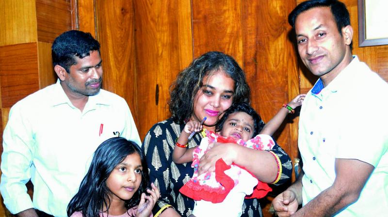 District collector Pravin Kumar hands over baby Sarayu for adoption to Vennisa Christina Sathur from Spain at his office in Vizag on Tuesday. (Photo: DC) District collector Pravin Kumar hands over baby Sarayu for adoption to Vennisa Christina Sathur from Spain at his office in Vizag on Tuesday. (Photo: DC)