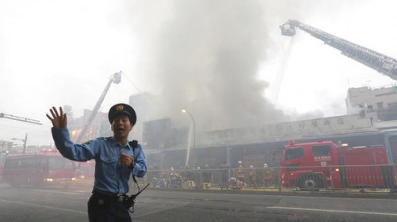 The fire broke out at a three-story building around 1:20 pm IST (0750 GMT), burning around 200 square metres (2,150 square feet) of the area, public broadcaster NHK said. (Photo: AP) The fire broke out at a three-story building around 1:20 pm IST (0750 GMT), burning around 200 square metres (2,150 square feet) of the area, public broadcaster NHK said. (Photo: AP)