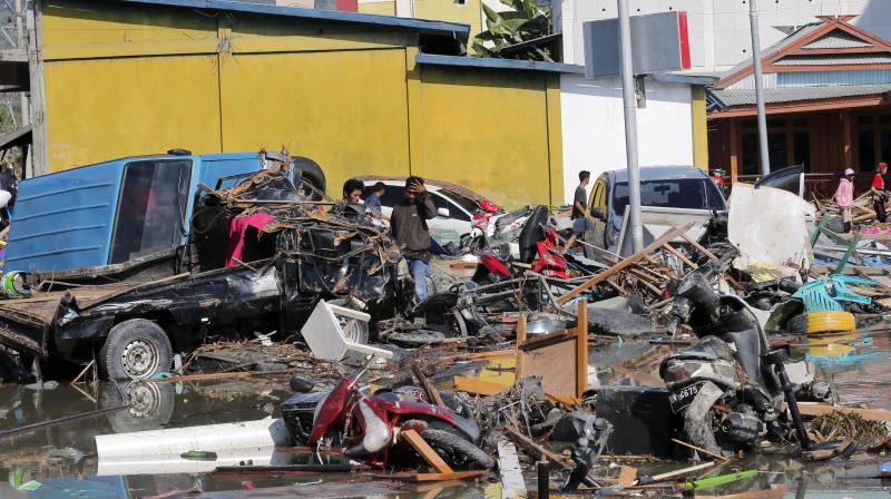 People survey the damage near a shopping mall following earthquakes and tsunami in Palu. (Photo: AP) People survey the damage near a shopping mall following earthquakes and tsunami in Palu. (Photo: AP)