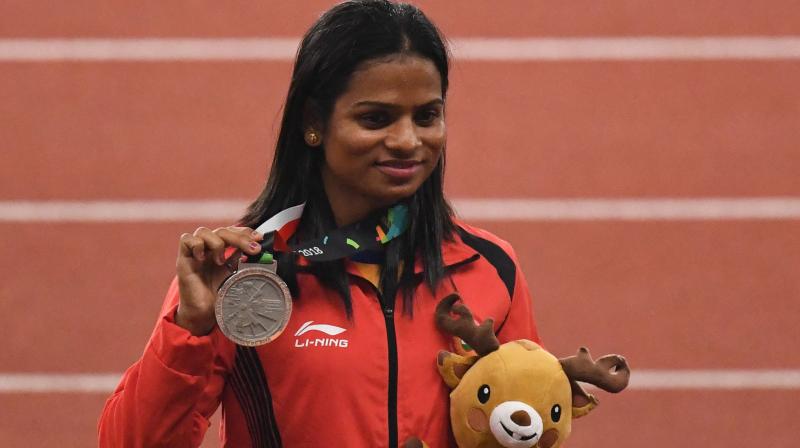 Indias Dutee Chand displays the womens 200m silver she won at the 2018 Asian Games in Jakarta. AFP Photo