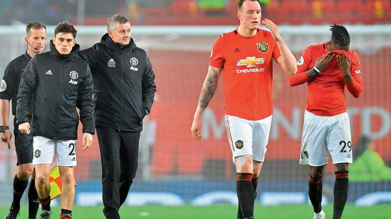 Manchester Uniteds Norwegian manager Ole Gunnar Solskjaer (3L) leaves the Old Trafford ground with his players Welsh midfielder Daniel James (2L), English defenders Phil Jones (2R) and Aaron Wan-Bissaka after the English Premier League match against Burnley. AFP Photo