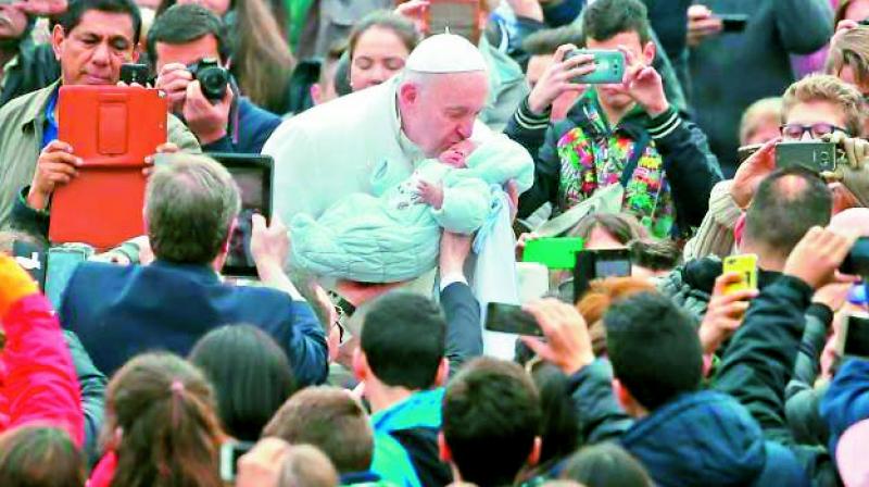 Pope Francis surrounded by a mass Pope Francis surrounded by a mass