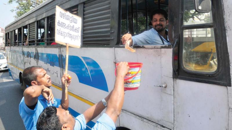 Dismissed empanelled conductors of the KSRTC, who are on an indefinite strike in front of the Secretariat, make a collection from a transport bus driver on Thursday. (A.V.MUZAFAR) Dismissed empanelled conductors of the KSRTC, who are on an indefinite strike in front of the Secretariat, make a collection from a transport bus driver on Thursday. (A.V.MUZAFAR)
