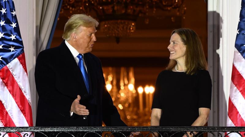 US President Donald Trump (L) stands with Judge Amy Coney Barrett after she was sworn in as a US Supreme Court Associate Justice during a ceremony on the South Lawn of the White House October 26, 2020, in Washington, DC. (AFP)