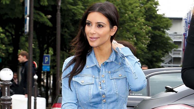Kim Kardasshian keeps it simple by pairin her outfit with a pair of sunglasses. Kim Kardasshian keeps it simple by pairin her outfit with a pair of sunglasses.