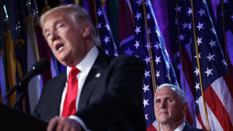 Vice president-elect Mike Pence, right, watches as President-elect Donald Trump speaks on Wednesday. (Photo: AP) Vice president-elect Mike Pence, right, watches as President-elect Donald Trump speaks on Wednesday. (Photo: AP)