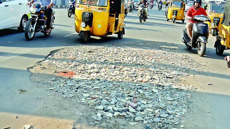 The heavily damaged road at Nampally left unattended by the civic body. The heavily damaged road at Nampally left unattended by the civic body.