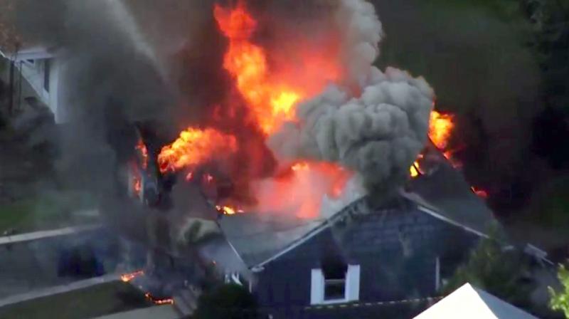 In this image take from video provided by WCVB in Boston, flames consume a home in Lawrence, Mass, a suburb of Boston. (Photo: AP) In this image take from video provided by WCVB in Boston, flames consume a home in Lawrence, Mass, a suburb of Boston. (Photo: AP)