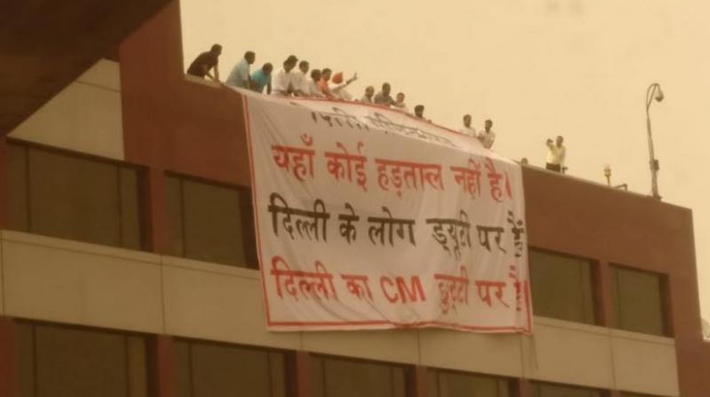 BJP leaders reportedly suspended a large banner from the roof of the Delhi Secretariat building saying: ‘Delhi Secretariat, there’s no strike here. People of Delhi are on duty. The Chief Minister of Delhi is on leave.’ (Photo: Twitter@ArvindKejriwal) BJP leaders reportedly suspended a large banner from the roof of the Delhi Secretariat building saying: ‘Delhi Secretariat, there’s no strike here. People of Delhi are on duty. The Chief Minister of Delhi is on leave.’ (Photo: Twitter@ArvindKejriwal)