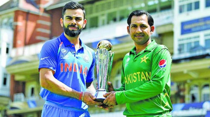 A file photo of India captain Virat Kohli and his counterpart Sarfaraz Ahmed posing with the Champions Trophy. (Photo: AFP) A file photo of India captain Virat Kohli and his counterpart Sarfaraz Ahmed posing with the Champions Trophy. (Photo: AFP)