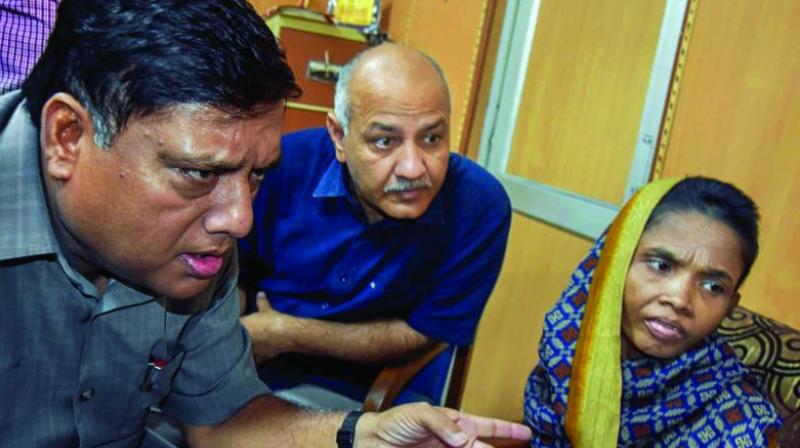 Delhi Deputy Chief Minister Manish Sisodia, along with an official, meets the mother of three girls who allegedly died of malnutrition at Mandawali in New Delhi on Thursday. (Photo: PTI) Delhi Deputy Chief Minister Manish Sisodia, along with an official, meets the mother of three girls who allegedly died of malnutrition at Mandawali in New Delhi on Thursday. (Photo: PTI)