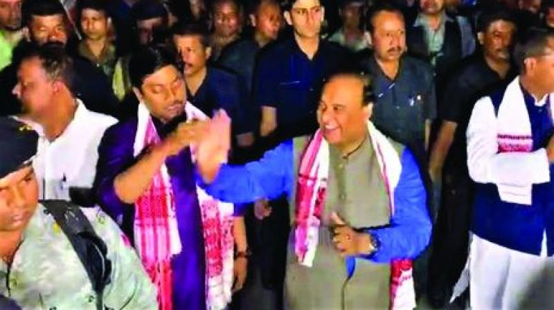 Assam finance minister (right) Himanta Biswa Sarma breaks into an impromptu jig during poll campaign. Assam finance minister (right) Himanta Biswa Sarma breaks into an impromptu jig during poll campaign.