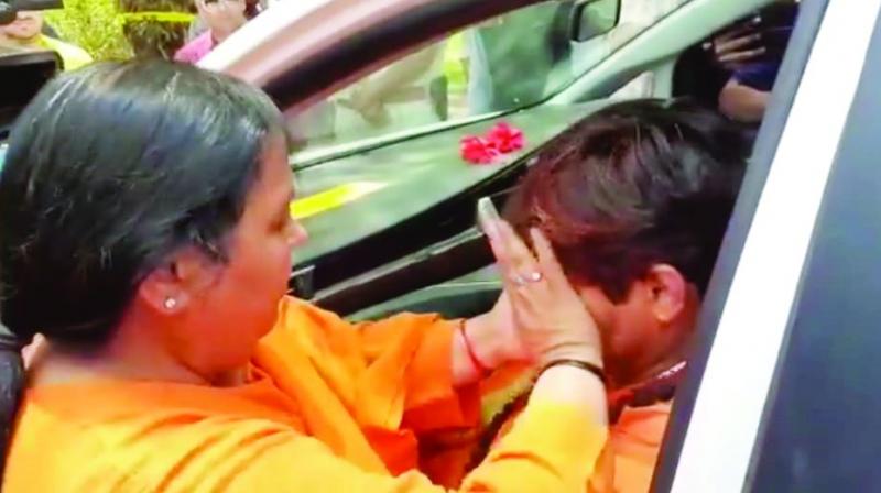 BJP leader wipes tears of party’s Bhopal candidate Pragya Singh Thakur on Monday. BJP leader wipes tears of party’s Bhopal candidate Pragya Singh Thakur on Monday.