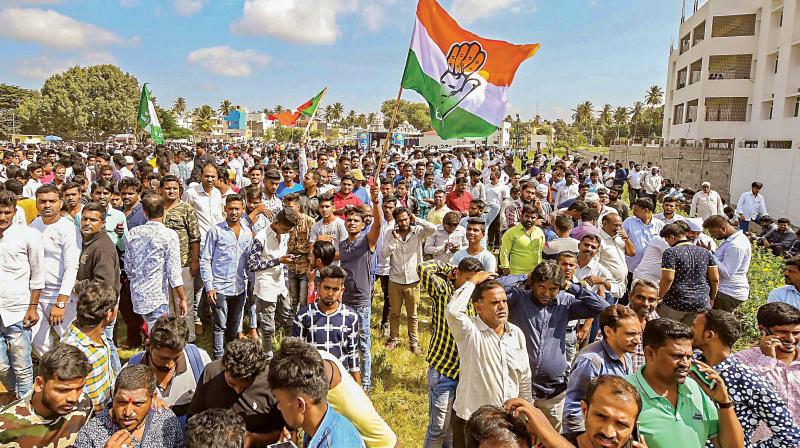 Congress workers celebrate their party’s win in urban local body polls, in Mysuru on Wednesday (Photo: PTI) Congress workers celebrate their party’s win in urban local body polls, in Mysuru on Wednesday (Photo: PTI)